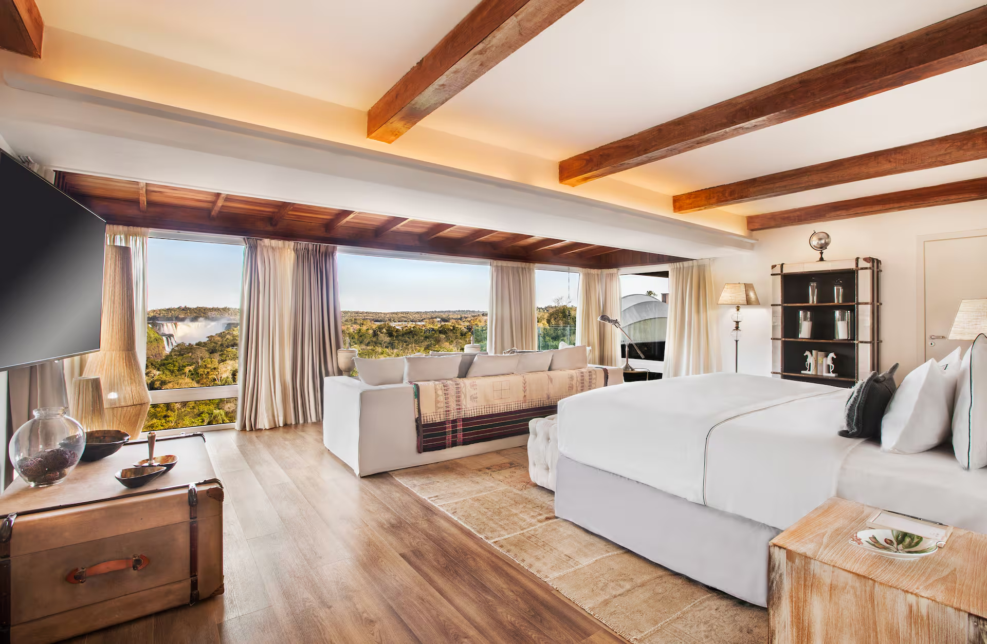 Luxury Gran Meliá suite with panoramic views, exposed wooden beams, and elegant furnishings