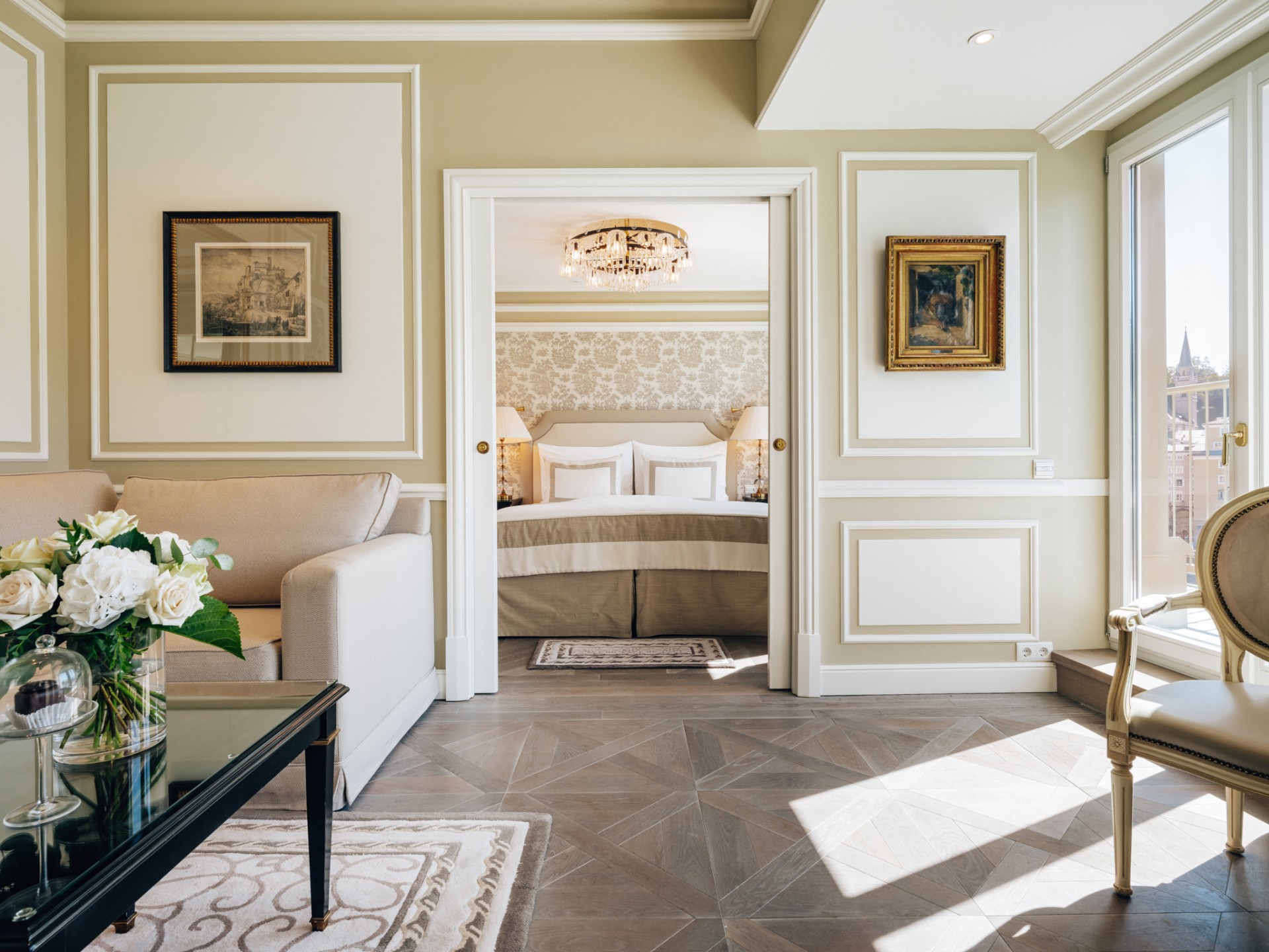 Spacious Presidential Suite living area with cream palette, contemporary furnishings, and views of St. Stephen's Cathedral