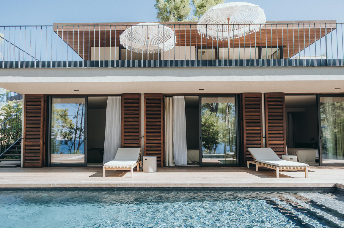 Villa Borovina with modern design, terrace with umbrellas, and heated swimming pool overlooking the Mediterranean