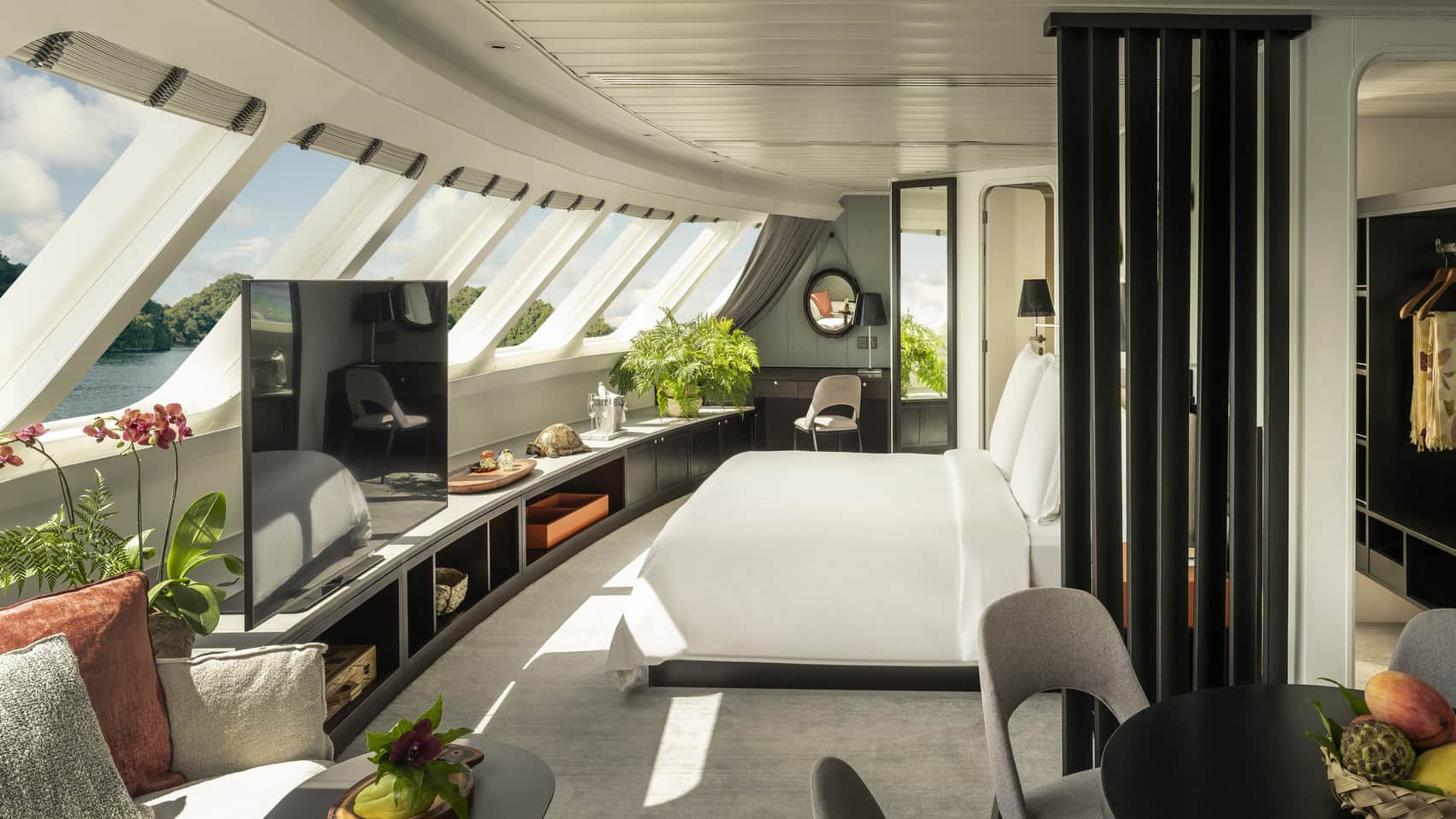 Four Seasons Explorer luxury yacht cabin with panoramic windows overlooking river views and modern furnishings